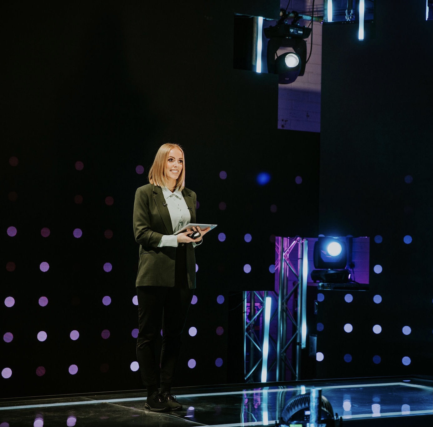 Chloe hosting a broadcast-style studio production